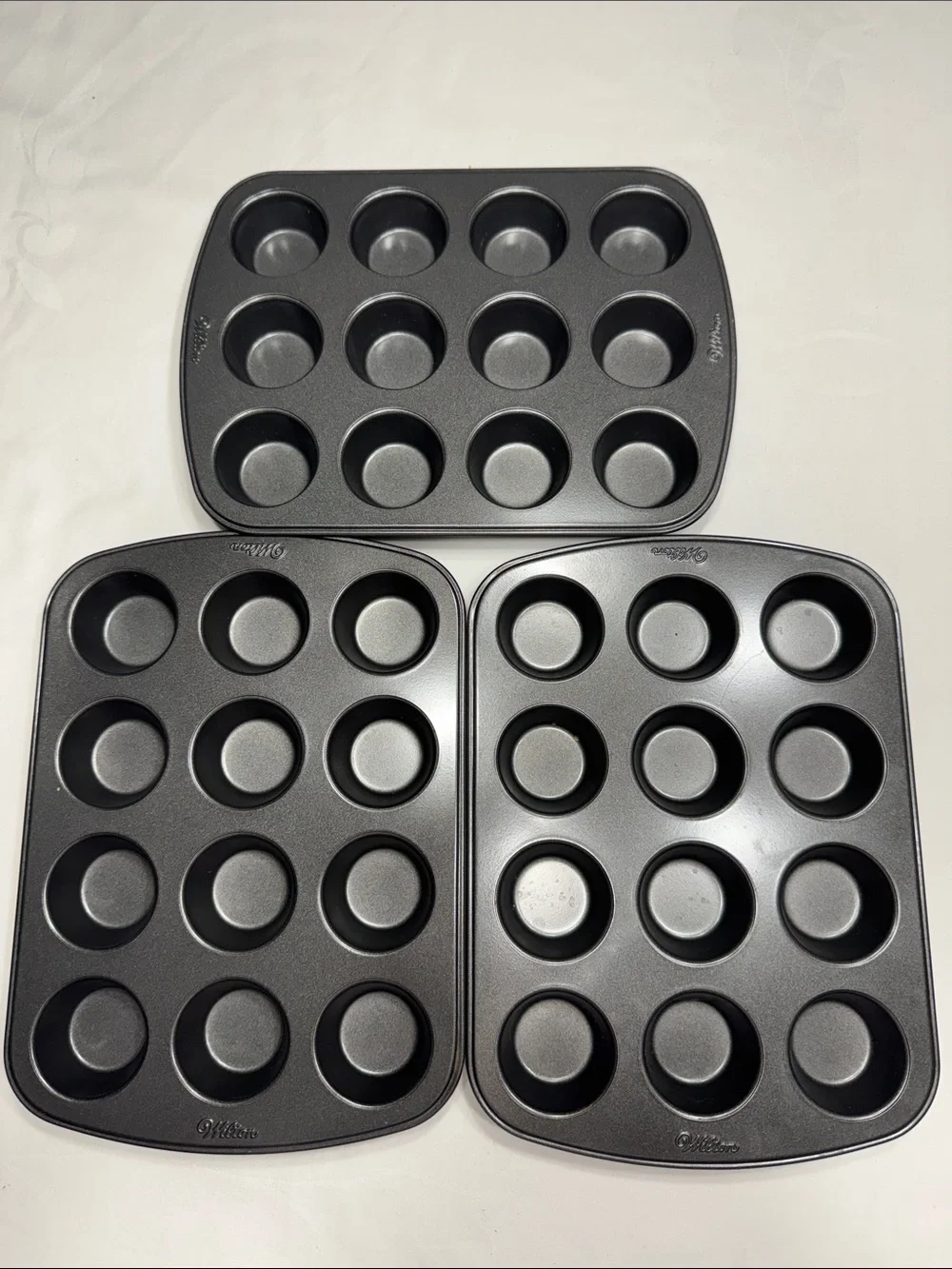 (3) like new Wilton mini muffin/cupcake none-stick baking pans.